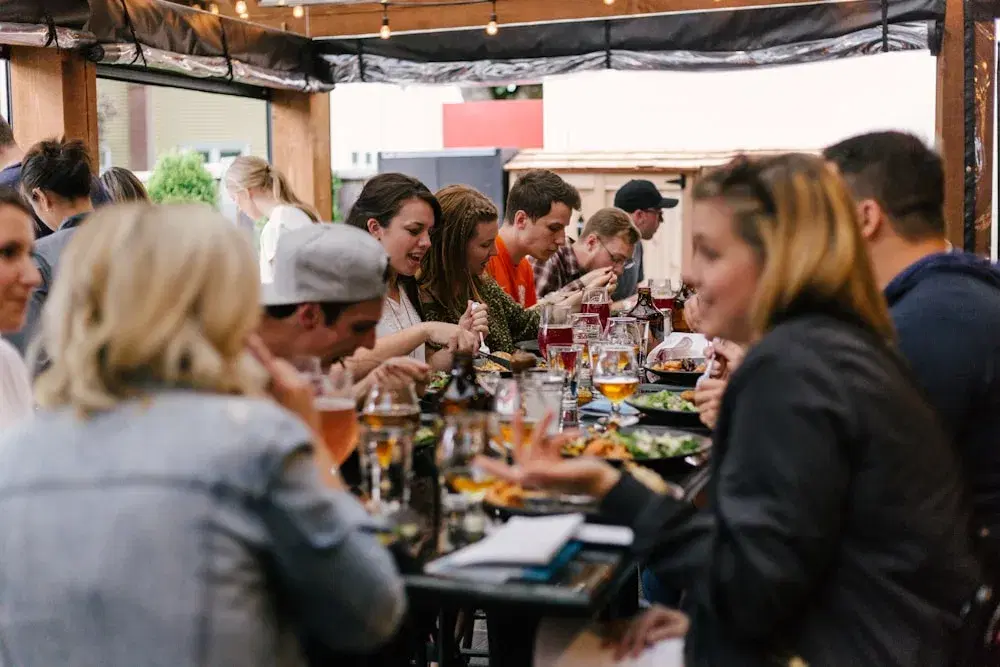 People sharing food and conversation around a long table